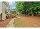 A home with a multi-level deck and a stone path through the landscaped yard at 1006 Amberton Ln, Powder Springs, GA 30127
