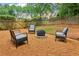 Cozy backyard with a fire pit surrounded by stylish seating and a wooden fence at 1006 Amberton Ln, Powder Springs, GA 30127