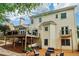 Expansive backyard featuring a wooden deck, patio, fire pit, and lush landscaping, ideal for outdoor entertaining at 1006 Amberton Ln, Powder Springs, GA 30127