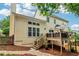 Scenic view of backyard featuring a wooden deck with outdoor seating and a stone walkway at 1006 Amberton Ln, Powder Springs, GA 30127