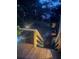 Backyard wooden deck overlooking landscaped yard with ambient lighting at 1006 Amberton Ln, Powder Springs, GA 30127