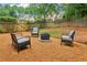 Backyard featuring a fire pit, a charming wooden fence and outdoor seating at 1006 Amberton Ln, Powder Springs, GA 30127