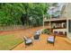 Backyard featuring a fire pit area, a deck, and mature trees creating a private outdoor space at 1006 Amberton Ln, Powder Springs, GA 30127