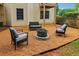 Inviting backyard seating area with a stone fire pit, chairs and bench seating at 1006 Amberton Ln, Powder Springs, GA 30127