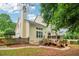 Large backyard with a wooden deck, stone pathway, and mature trees, creating an inviting outdoor space at 1006 Amberton Ln, Powder Springs, GA 30127