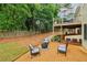 Backyard featuring a fire pit area, a deck, and mature trees for privacy and shade at 1006 Amberton Ln, Powder Springs, GA 30127