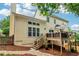 View of the backyard with a multi-level deck, stone pathway, and landscaped yard at 1006 Amberton Ln, Powder Springs, GA 30127