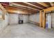 Unfinished basement with exposed wooden beams, concrete walls and a fireplace at 1006 Amberton Ln, Powder Springs, GA 30127