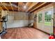 Finished basement with wood floor, door leading to the outside, and room for exercise equipment at 1006 Amberton Ln, Powder Springs, GA 30127