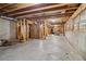 Large unfinished basement space with exposed beams, concrete walls and many windows at 1006 Amberton Ln, Powder Springs, GA 30127