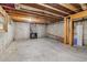 Unfinished basement space with exposed beams, concrete walls, and a fireplace at 1006 Amberton Ln, Powder Springs, GA 30127