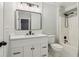 Updated bathroom with a large mirror, new fixtures, and white cabinets at 1006 Amberton Ln, Powder Springs, GA 30127