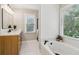 Spa-like bathroom with soaking tub, modern finishes, and natural light at 1006 Amberton Ln, Powder Springs, GA 30127