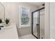 Bathroom featuring a modern vanity, mirror, and shower with sliding glass doors at 1006 Amberton Ln, Powder Springs, GA 30127