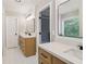 Bright bathroom with double vanities, quartz countertops, and white tiled flooring at 1006 Amberton Ln, Powder Springs, GA 30127