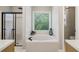 Bathroom featuring a large soaking tub, tiled shower, and a private toilet at 1006 Amberton Ln, Powder Springs, GA 30127