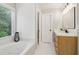 This bathroom features a large tub with jets and a light wood vanity at 1006 Amberton Ln, Powder Springs, GA 30127