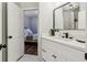 Light-filled bathroom features a modern vanity and fixtures, connecting to an adjacent bedroom at 1006 Amberton Ln, Powder Springs, GA 30127