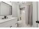 Charming bathroom with a white vanity, modern fixtures, and a shower with grey curtain at 1006 Amberton Ln, Powder Springs, GA 30127