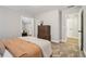 Bedroom with neutral walls, plush carpet, a dresser and a doorway leading to another room at 1006 Amberton Ln, Powder Springs, GA 30127