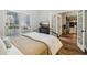 Bedroom with a TV on a black chest of drawers and doorway leading to a space with built in shelves at 1006 Amberton Ln, Powder Springs, GA 30127