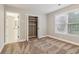 Bright carpeted bedroom with closet and neutral walls, creating a peaceful retreat with organized storage at 1006 Amberton Ln, Powder Springs, GA 30127