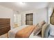 Bedroom with neutral walls, plush carpet, a dresser and an open closet with shelves at 1006 Amberton Ln, Powder Springs, GA 30127