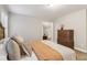 This bedroom features a bed, dresser, neutral paint, and a window at 1006 Amberton Ln, Powder Springs, GA 30127