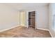 Spacious bedroom with walk-in closet, carpet, and a large window at 1006 Amberton Ln, Powder Springs, GA 30127