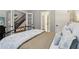 Relaxing bedroom with natural light, neutral paint, and a glimpse of the stairway through french doors at 1006 Amberton Ln, Powder Springs, GA 30127
