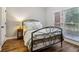 Cozy bedroom features wood floors, neutral walls, and a black metal bed frame, creating a tranquil retreat at 1006 Amberton Ln, Powder Springs, GA 30127