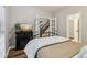 Bedroom featuring an iron frame bed, fireplace with tv, and staircase access through french doors at 1006 Amberton Ln, Powder Springs, GA 30127