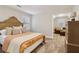 Bedroom with neutral walls, plush carpet, a bed with an orange blanket and a dresser at 1006 Amberton Ln, Powder Springs, GA 30127