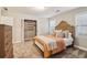 Bedroom with neutral walls, plush carpet, an orange blanket and an open closet with shelves at 1006 Amberton Ln, Powder Springs, GA 30127