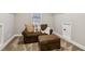 Bonus room with neutral walls, plush carpet, a brown sofa and ottoman, and a window at 1006 Amberton Ln, Powder Springs, GA 30127