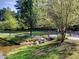Scenic community park featuring lush greenery, a tranquil pond, and a charming walking path with a small bridge at 1006 Amberton Ln, Powder Springs, GA 30127