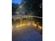 Cozy wooden deck with decorative lights, potted plants, and a patterned rug, perfect for outdoor relaxation at 1006 Amberton Ln, Powder Springs, GA 30127