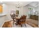 Bright dining area features wood table, chandelier, and sliding glass door to the backyard at 1006 Amberton Ln, Powder Springs, GA 30127