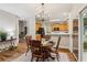 Bright eat-in kitchen area features wood table and chairs with views into the kitchen at 1006 Amberton Ln, Powder Springs, GA 30127