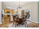 Cozy dining area adjacent to the kitchen featuring wood floors, a chandelier, and access to the deck at 1006 Amberton Ln, Powder Springs, GA 30127