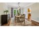 Charming dining room with wood floors, decorative rug, and French doors leading to the patio at 1006 Amberton Ln, Powder Springs, GA 30127