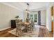 Charming dining room with wood floors, decorative rug, and French doors leading to the patio at 1006 Amberton Ln, Powder Springs, GA 30127