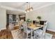 Well-lit dining room with wood floors, decorative rug, and view into office area at 1006 Amberton Ln, Powder Springs, GA 30127