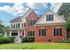 Charming two-story home with a brick facade, black shutters, and a well-manicured lawn at 1006 Amberton Ln, Powder Springs, GA 30127