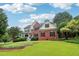 Beautiful two-story brick home with well-manicured front yard and inviting curb appeal at 1006 Amberton Ln, Powder Springs, GA 30127