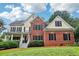 Charming two-story home with a brick facade, shutters, a welcoming porch, and a well-manicured lawn at 1006 Amberton Ln, Powder Springs, GA 30127