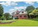 Beautiful two-story brick home with a well-manicured lawn and a welcoming front porch at 1006 Amberton Ln, Powder Springs, GA 30127