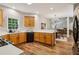 Well-lit kitchen features wood cabinets, stainless steel appliances, and views into dining and living areas at 1006 Amberton Ln, Powder Springs, GA 30127