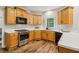 Well-equipped kitchen with wood cabinets, stainless steel appliances, and plenty of counter space at 1006 Amberton Ln, Powder Springs, GA 30127