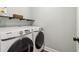 Modern laundry room with front-load washer and dryer, maximizing space and efficiency in a sleek design at 1006 Amberton Ln, Powder Springs, GA 30127